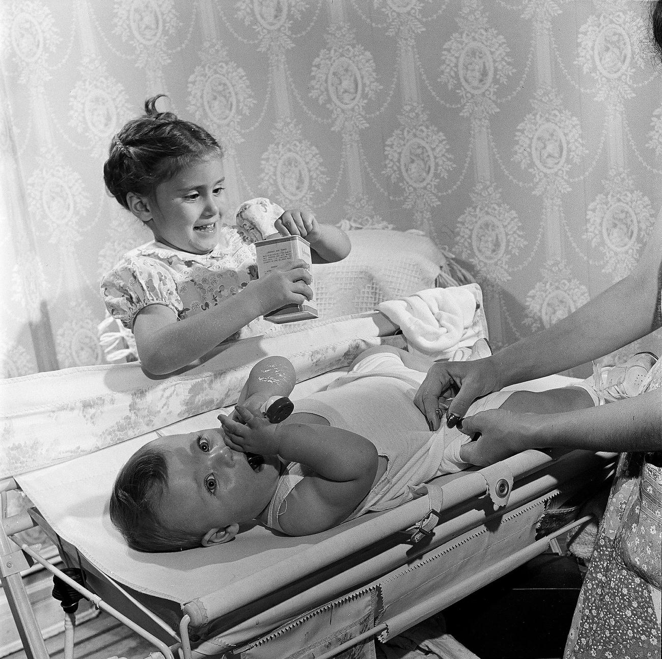 Girl Changing Her Baby Brother'S Diaper, 1947