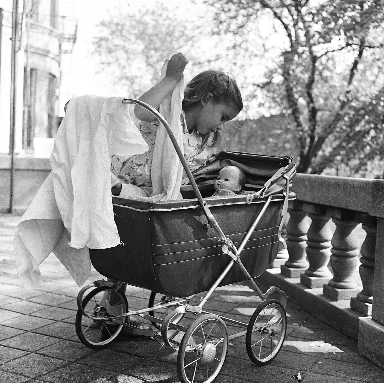 Girl Playing With Doll In Baby Carriage, 1947