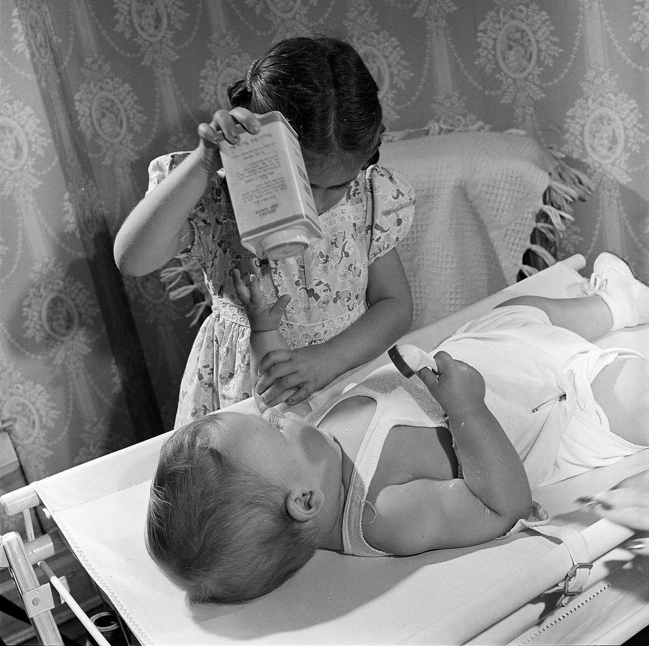 Girl Taking Care Of Her Baby Brother, 1947