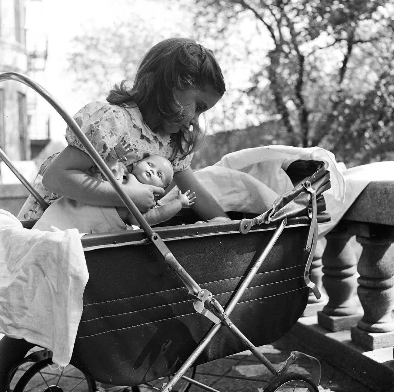 Girl Playing With Doll In Baby Carriage, 1947