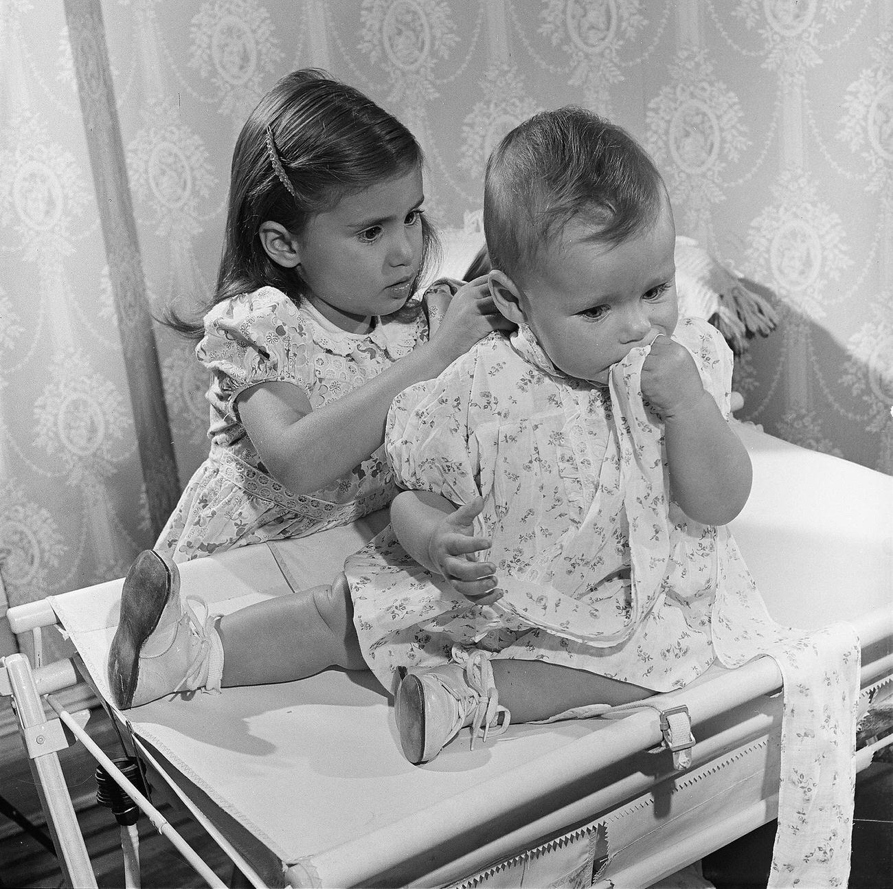 Girl Taking Care Of Her Baby Brother, 1947