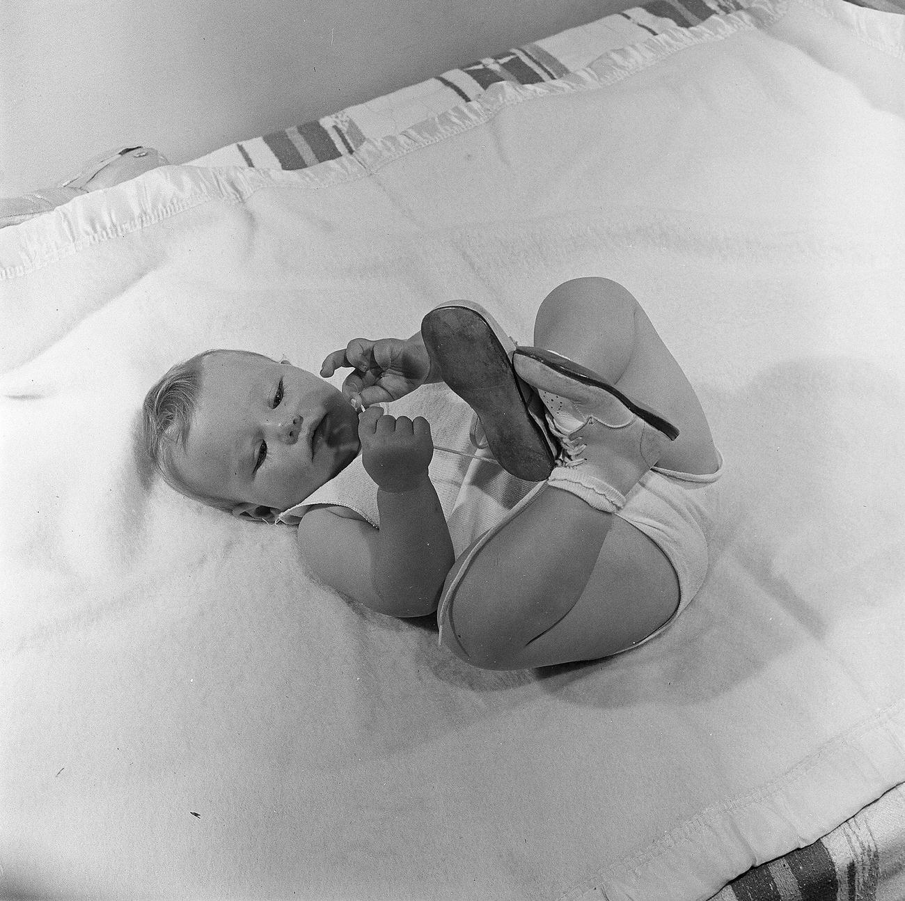 Baby Boy Playing In His Bassinet, 1947