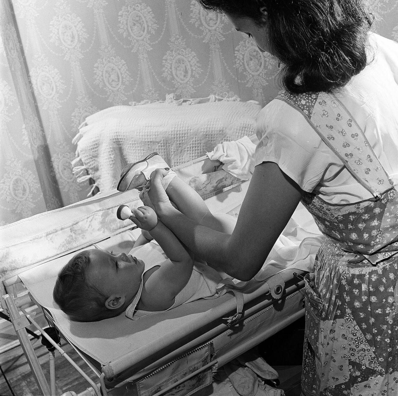 Mother Changing Baby Boy'S Diaper, 1947