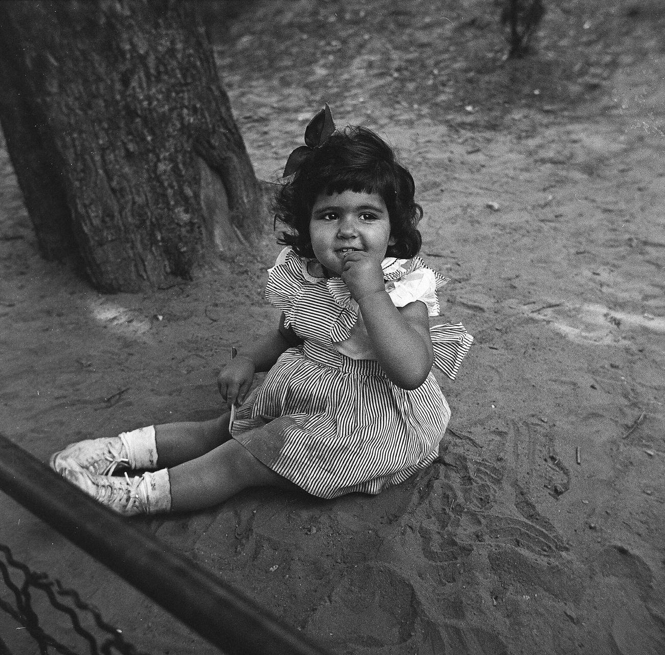 Young Girl Sitting In Sand At A Park, 1944