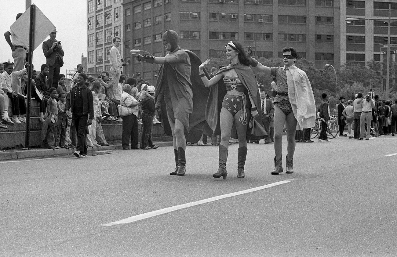 Wonder Woman, Batman, And Robin Crossing Brooklyn Bridge, 1983