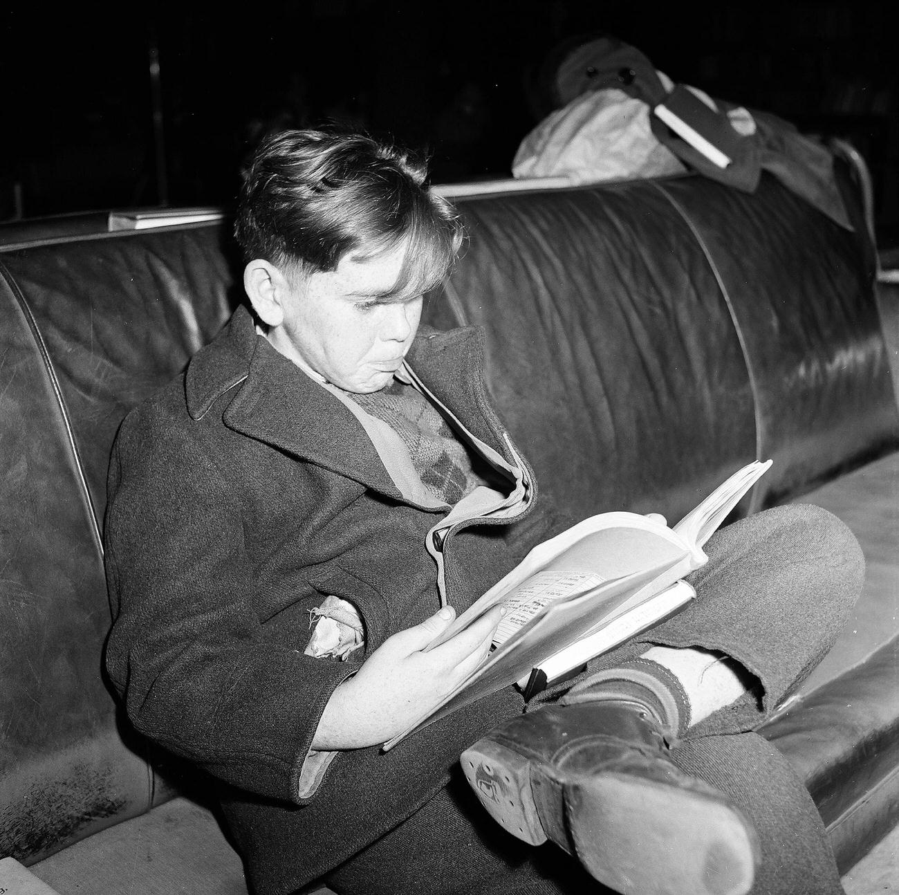 Young Boy Focused On Reading, 1947
