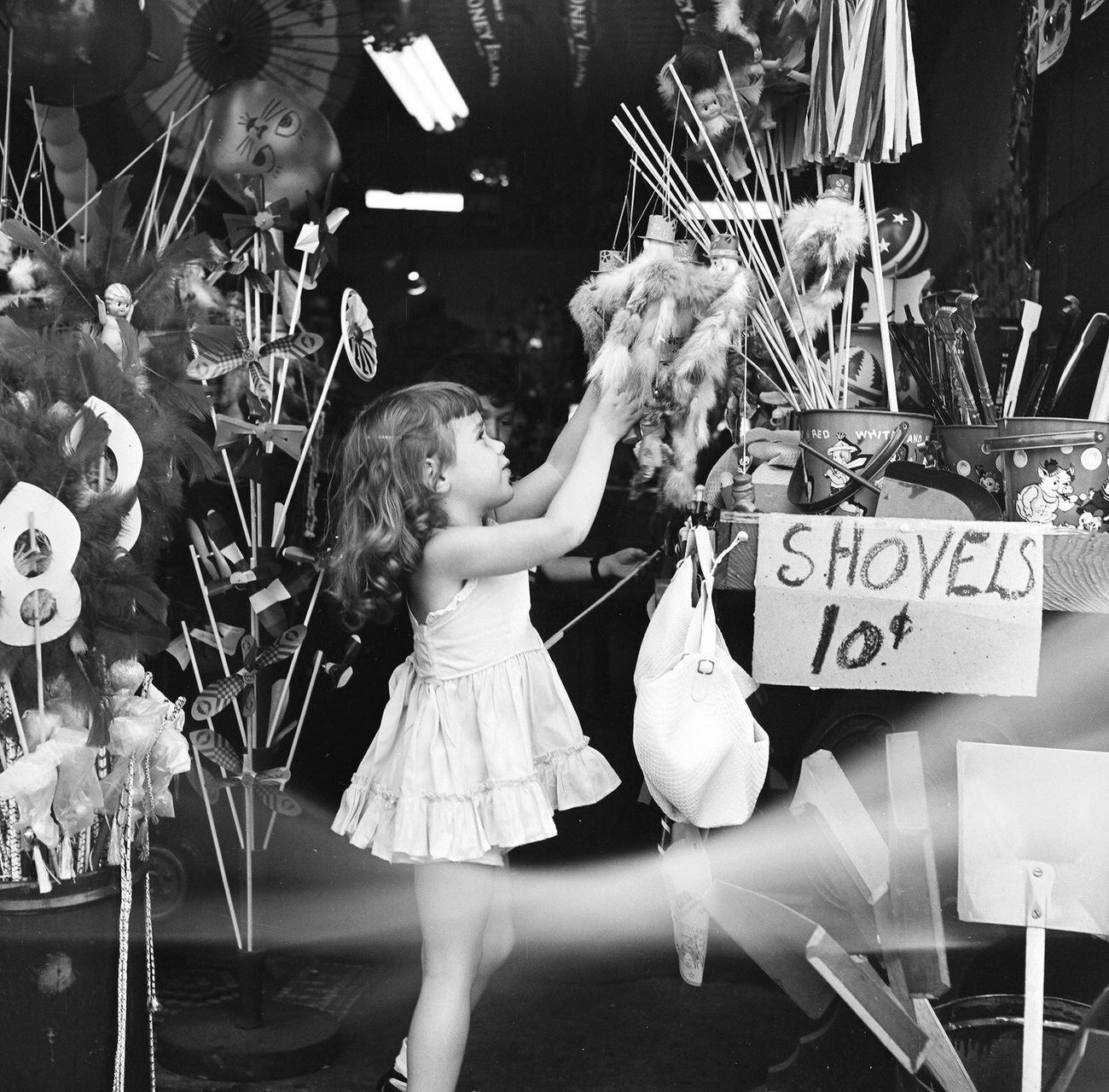 Girl Choosing A Toy From A Storefront Vendor, 1948