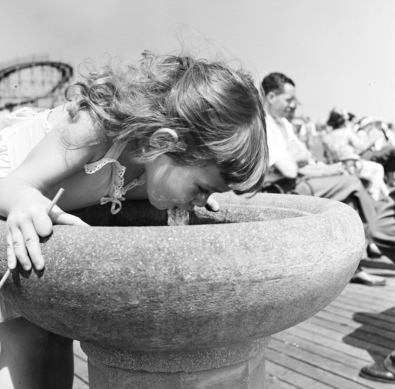 Girl Drinking From Water Fountain On Boardwalk, 1948