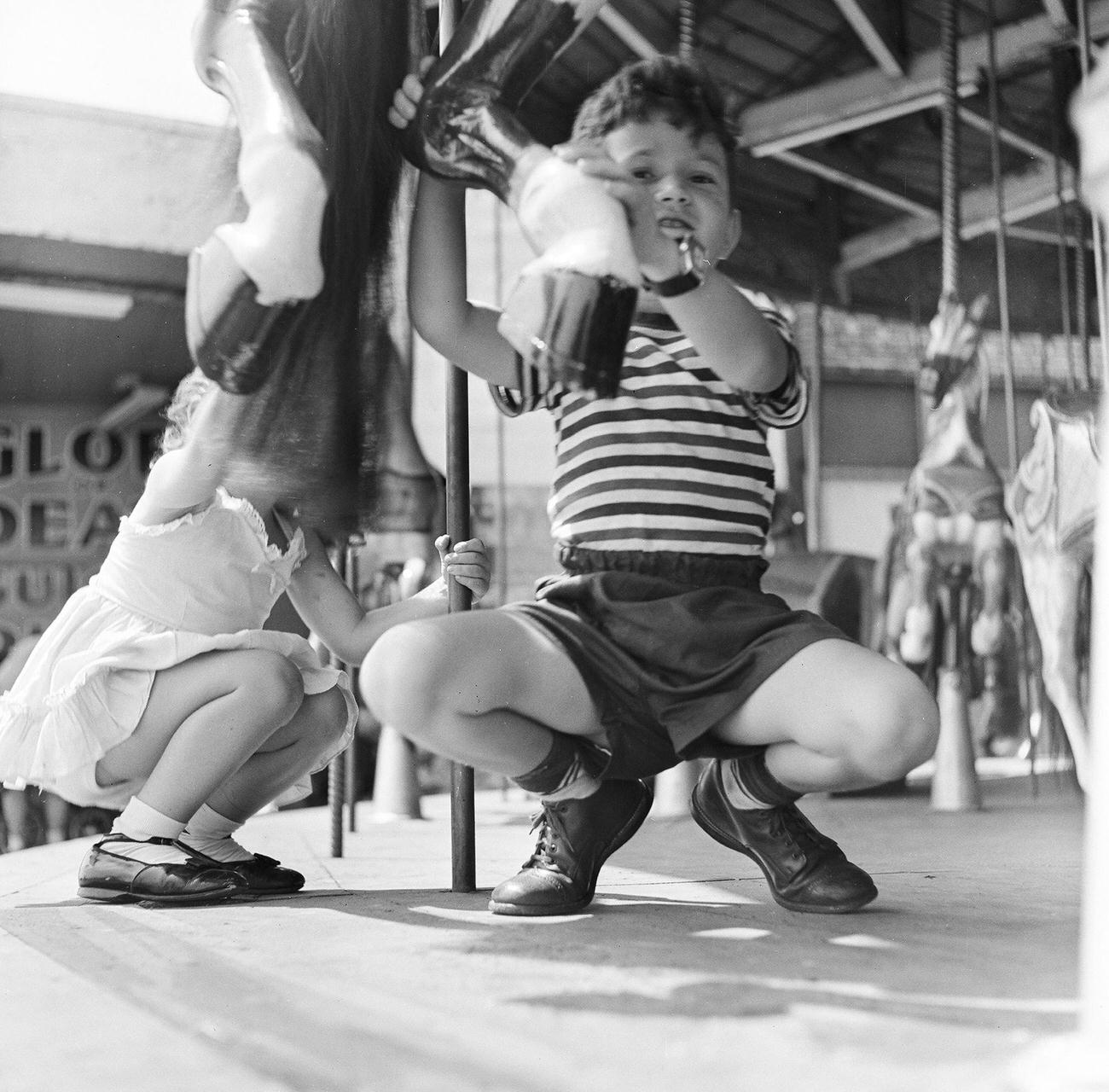 Siblings On Carousel At Amusement Park, 1948