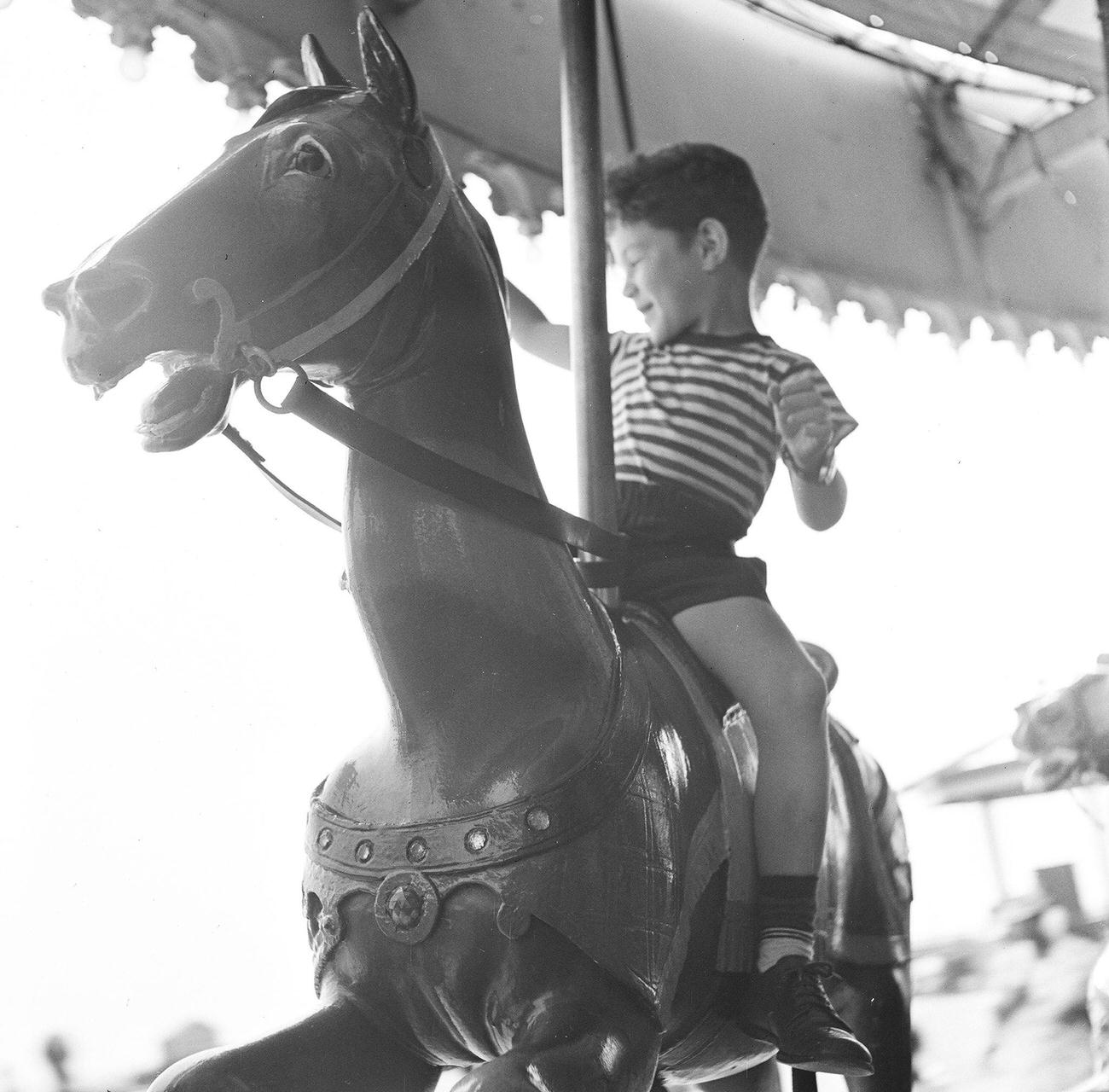 Boy On Carousel Ride At Amusement Park, 1948