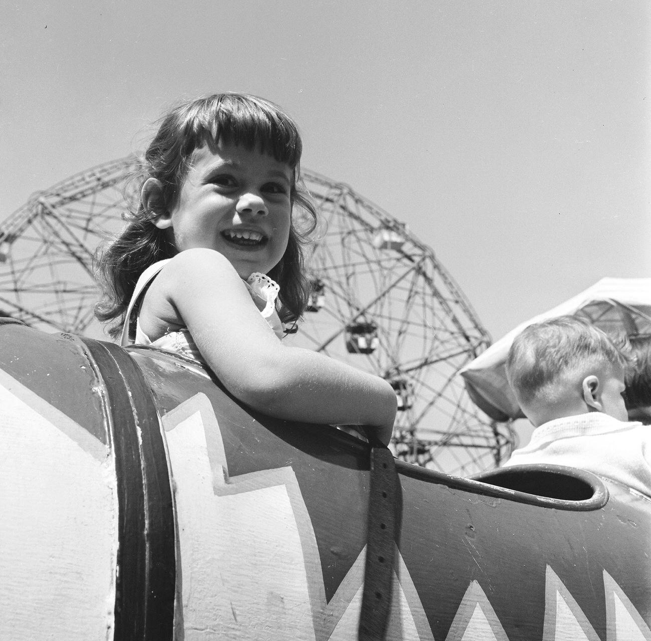 Girl In Front Of Ferris Wheel At Amusement Park, 1948