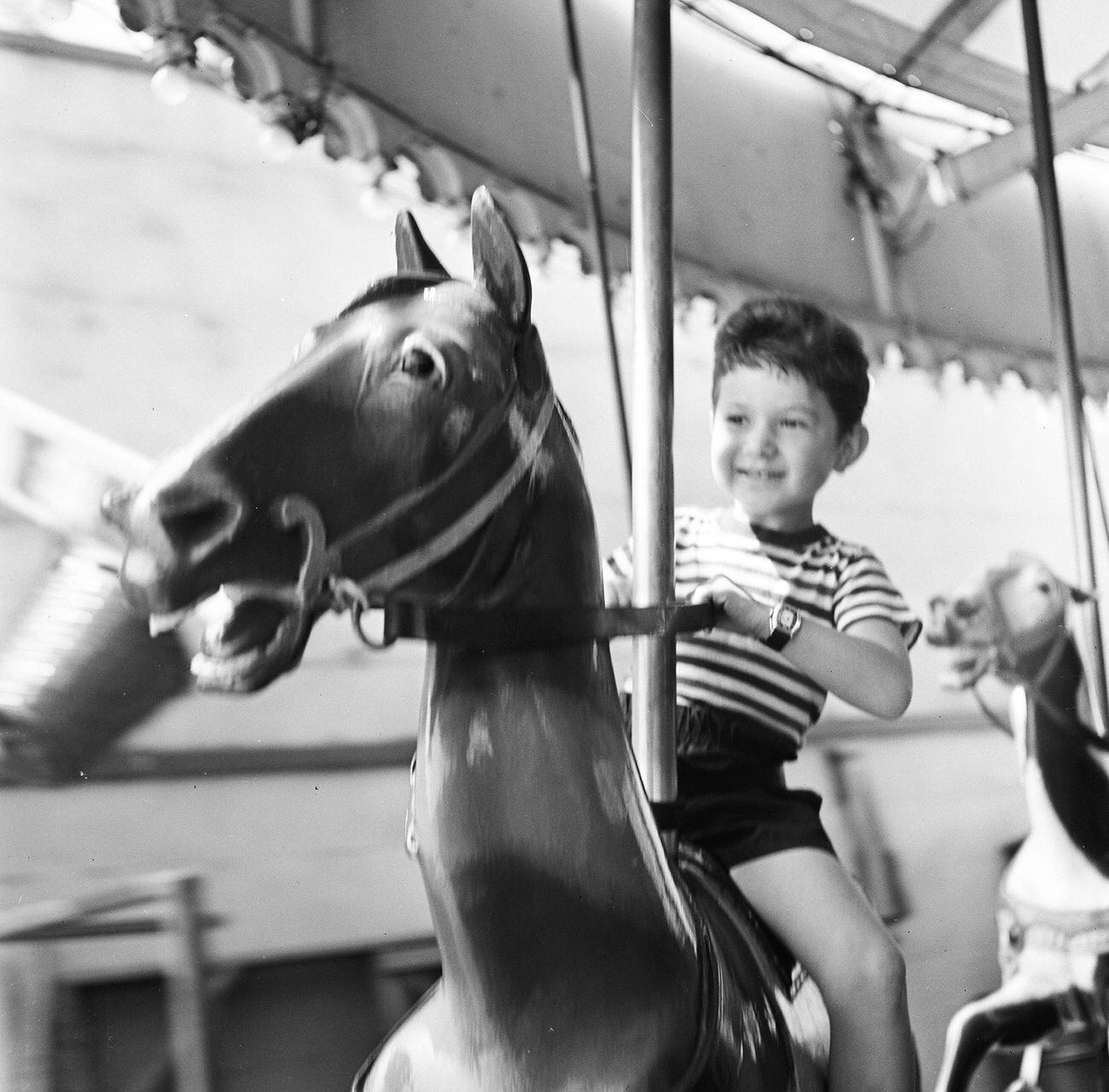 Boy Pulling Reins On Carousel Ride, 1948