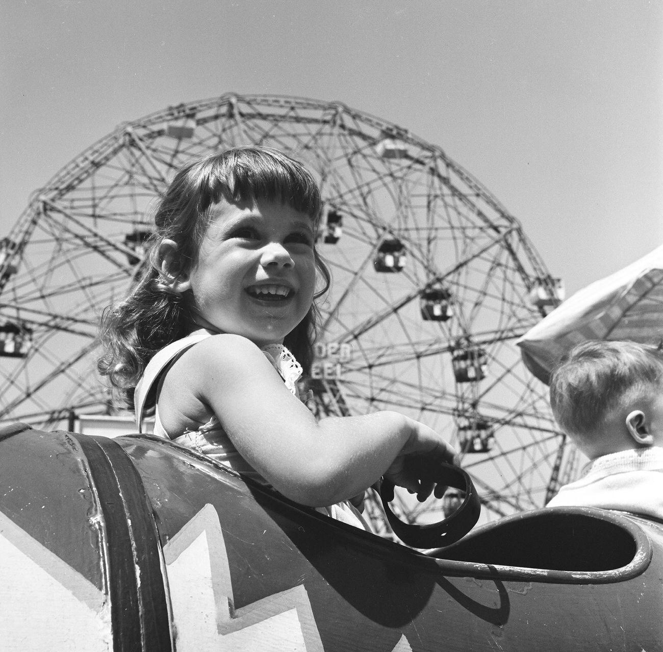 Girl Anticipating Ride, Ferris Wheel In Background, 1948
