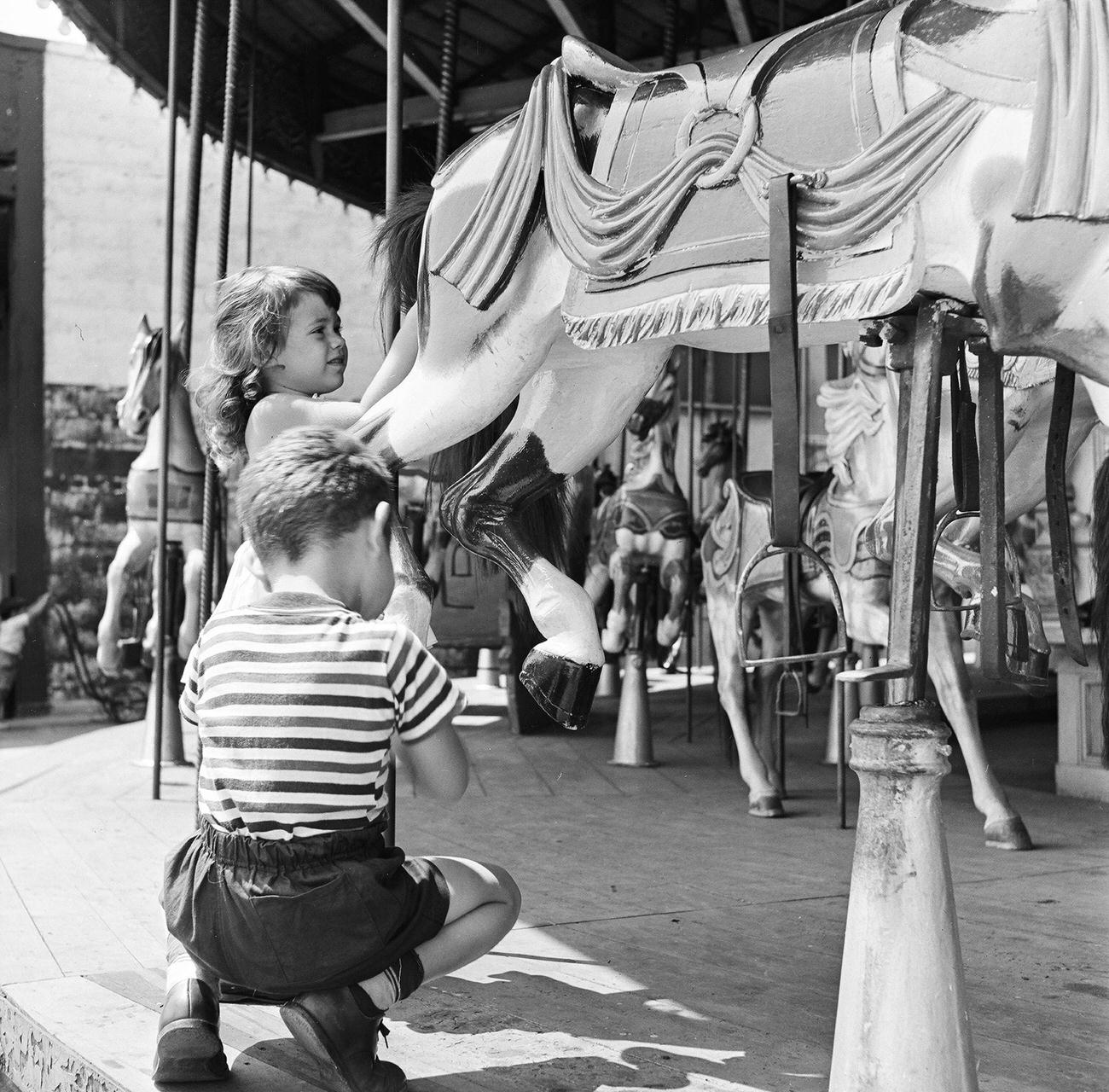 Young Girl Prepares To Board Carousel Horse At Coney Island, 1948