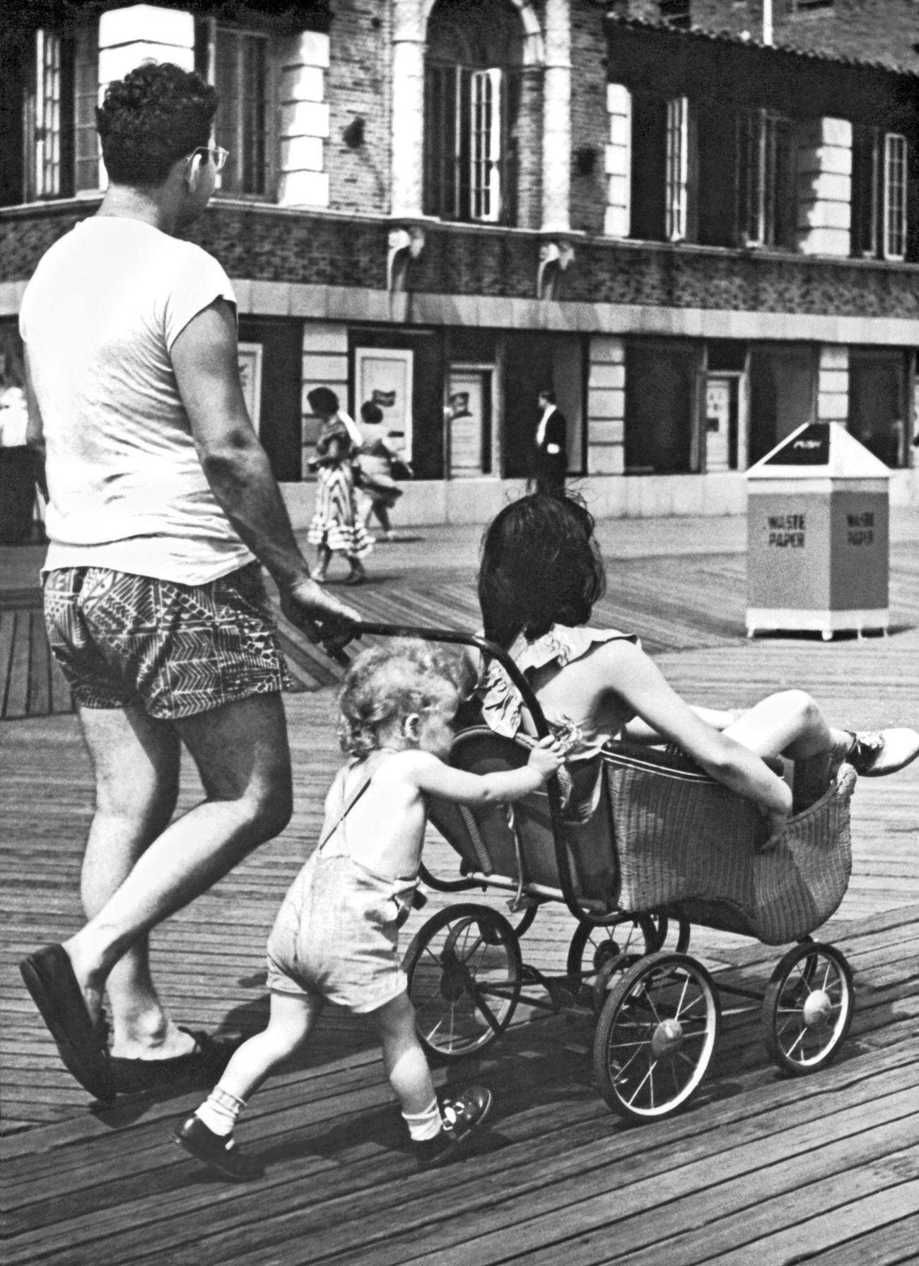 Child Pushes Stroller As Mom Takes A Ride At Coney Island, August 28, 1948