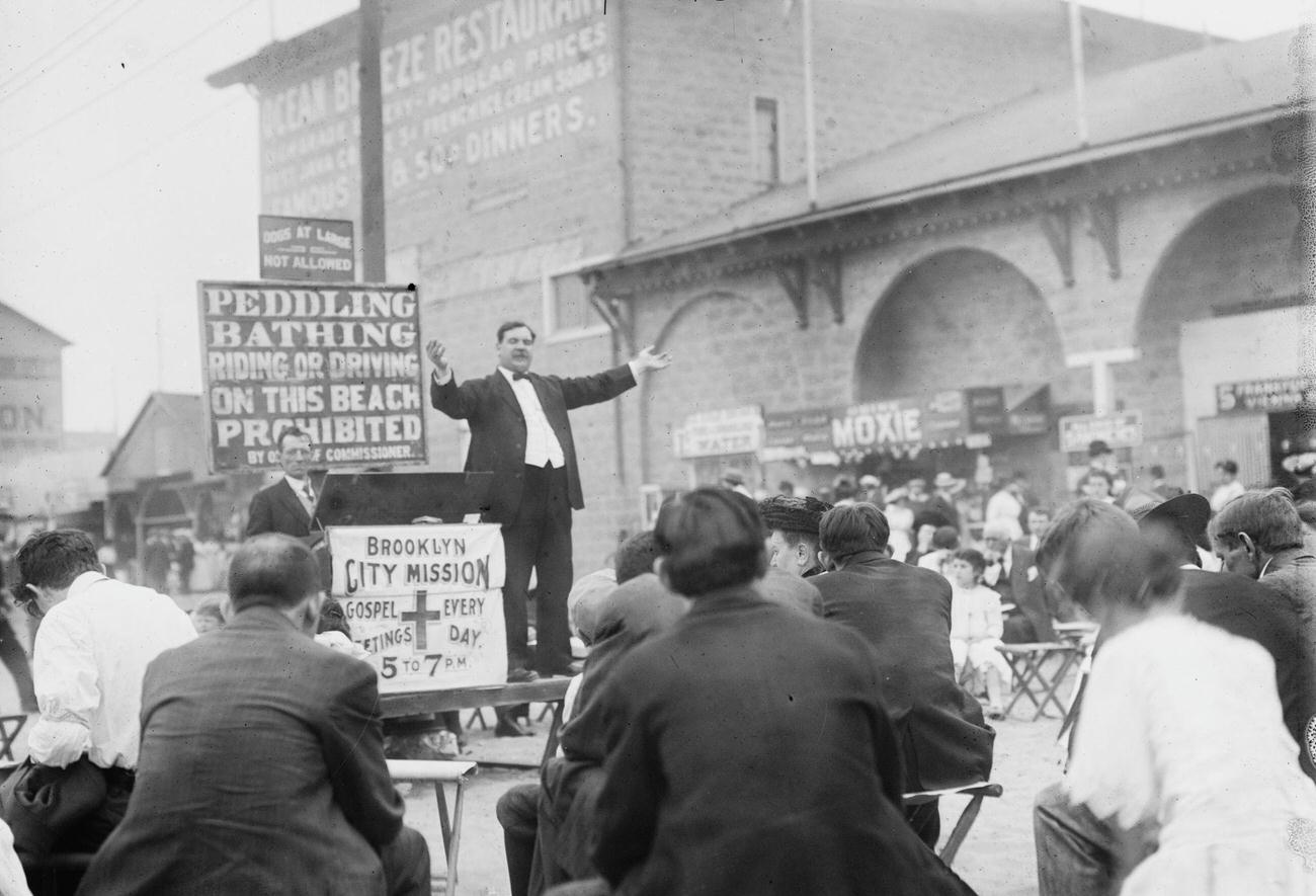 Preacher Exhorts Crowds Amid Revelry At Coney Island, Circa 1900