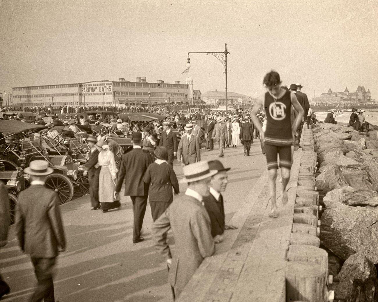 1915 Coney Island Boardwalk, Beach, Pedestrians, And Autos.