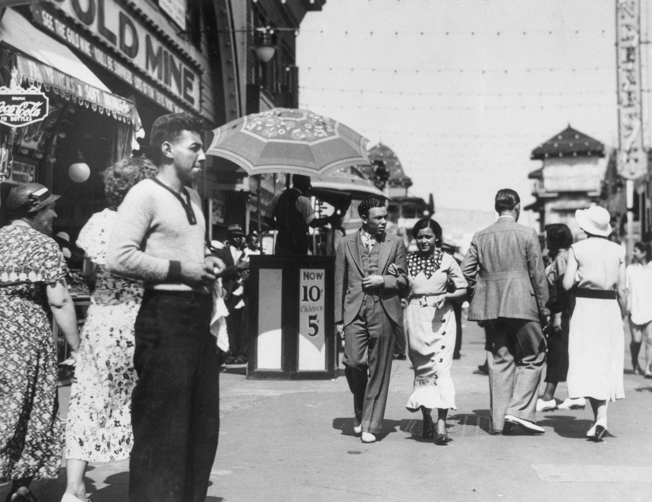 Couple Walks Down Busy Entertainment Strip In Coney Island, 1934