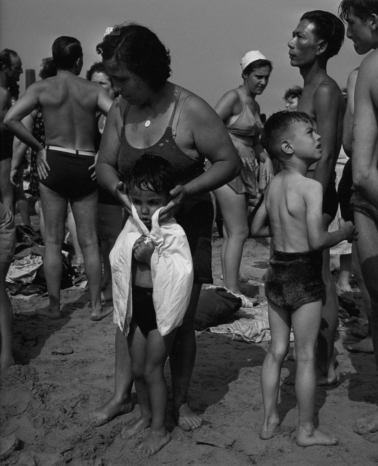 Woman Helps Child Dry Off At Coney Island Beach, 1938