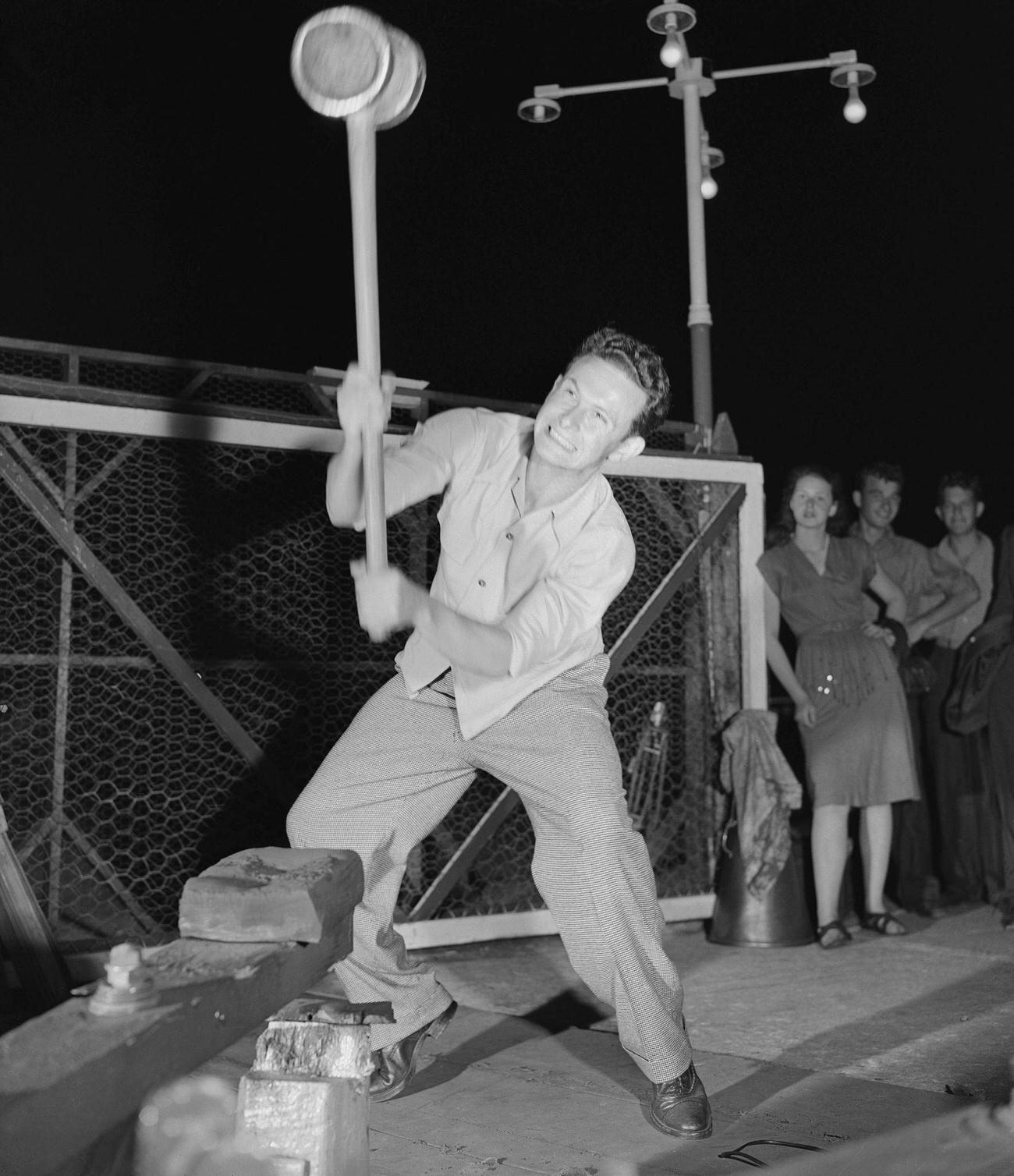 Swinging Sledge Hammer To Ring Bell, 1946