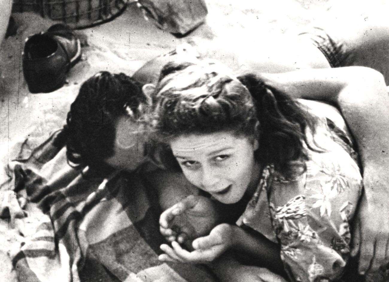 Young Woman Glances At Camera While Embracing Man, Late 1930S