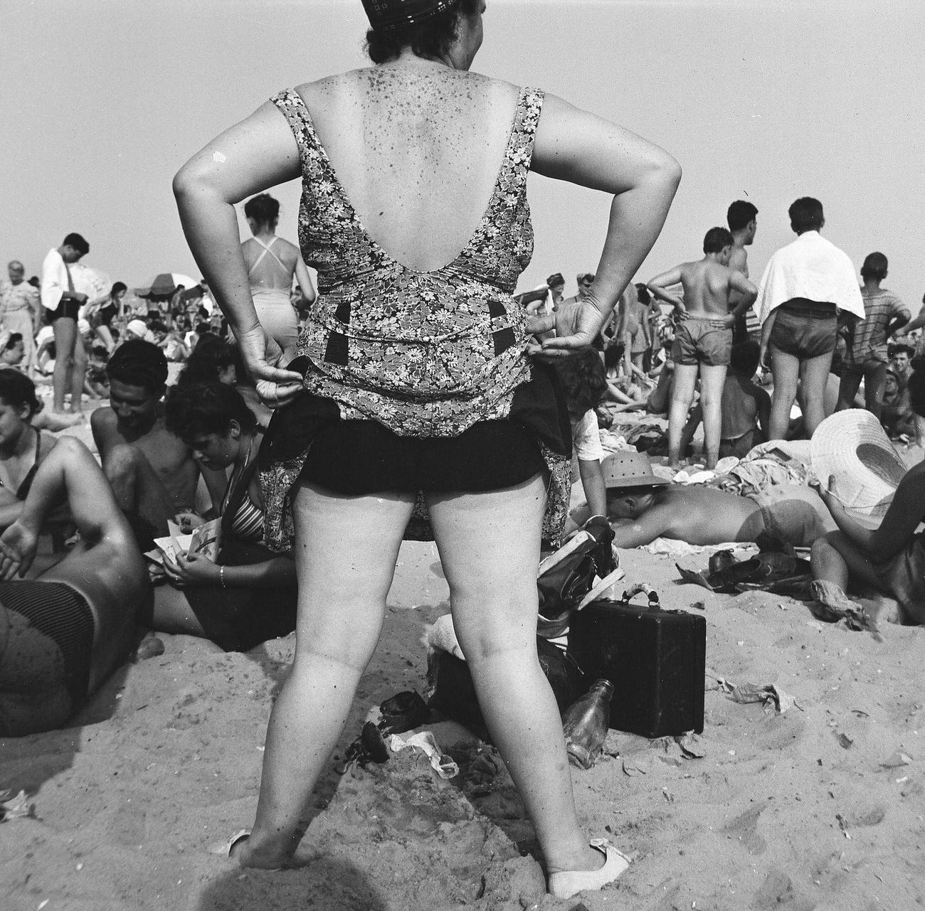 Woman Adjusts Skirt Of Swimsuit On Crowded Beach, 1944