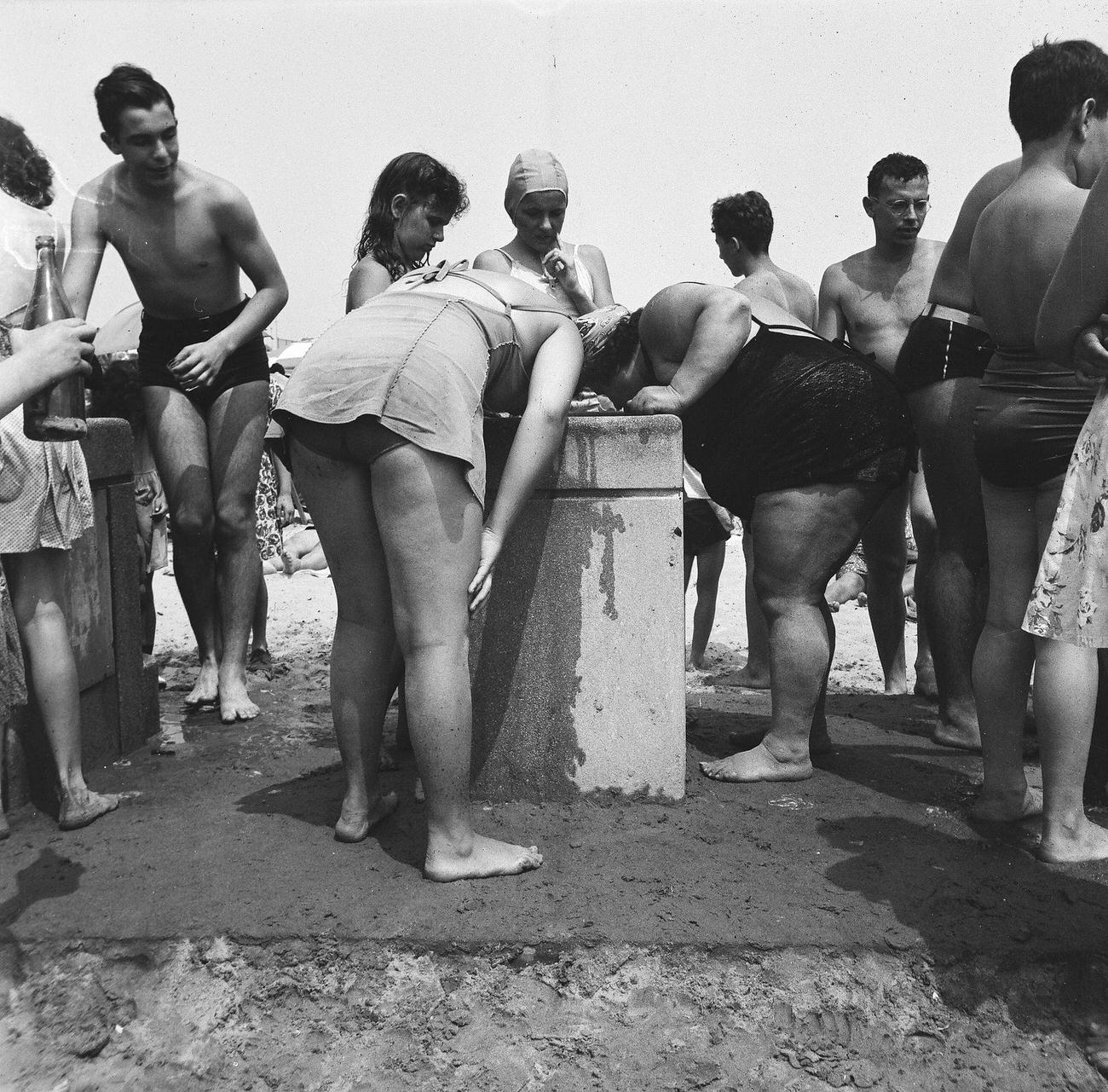 Beachgoers Gather Around Water Fountain, 1944