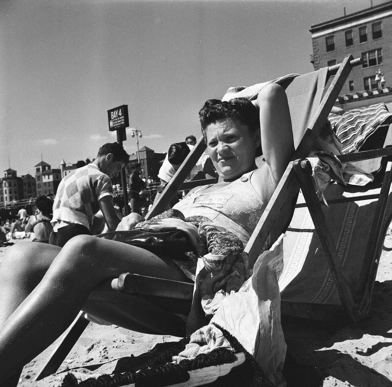 Woman Sitting On Folding Chair On The Sand, 1944