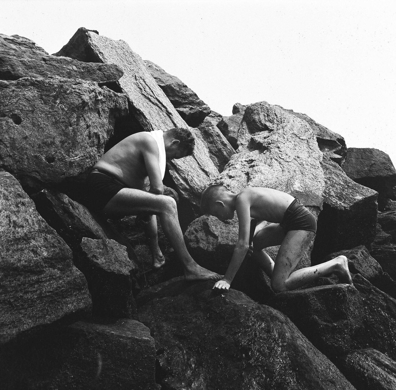 Man And Boy Looking Down From Rocks At Coney Island Beach, 1944