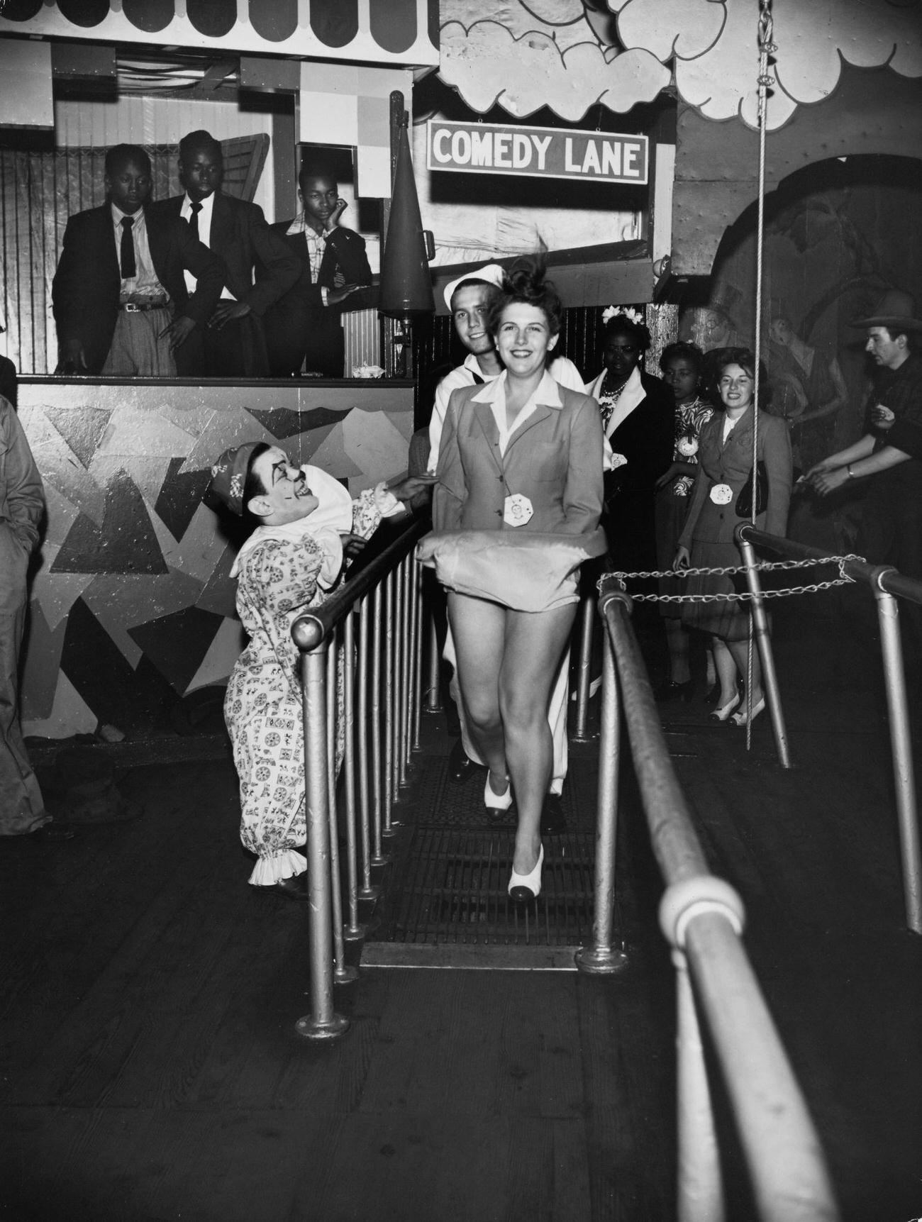 Clown Helps Woman On Trick Gratings At Steeplechase Park, June 1, 1944