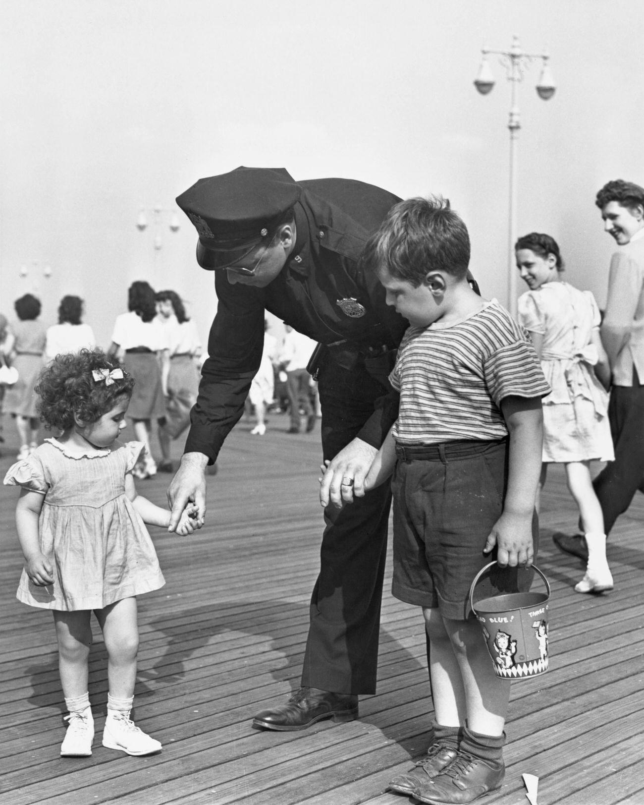 Policeman Assists Lost Children At Coney Island, August 13, 1944