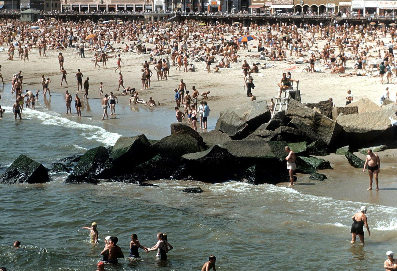 Coney Island Boardwalk With Sunbathers And Swimmers On The Beach, 1948