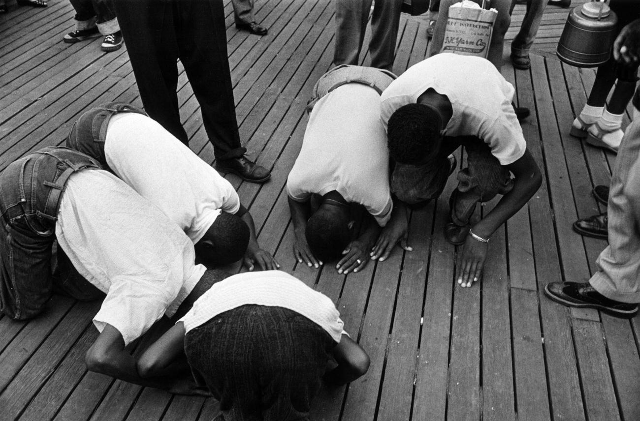 Youths Peer Down Cracks In Coney Island Boardwalk, 1952.