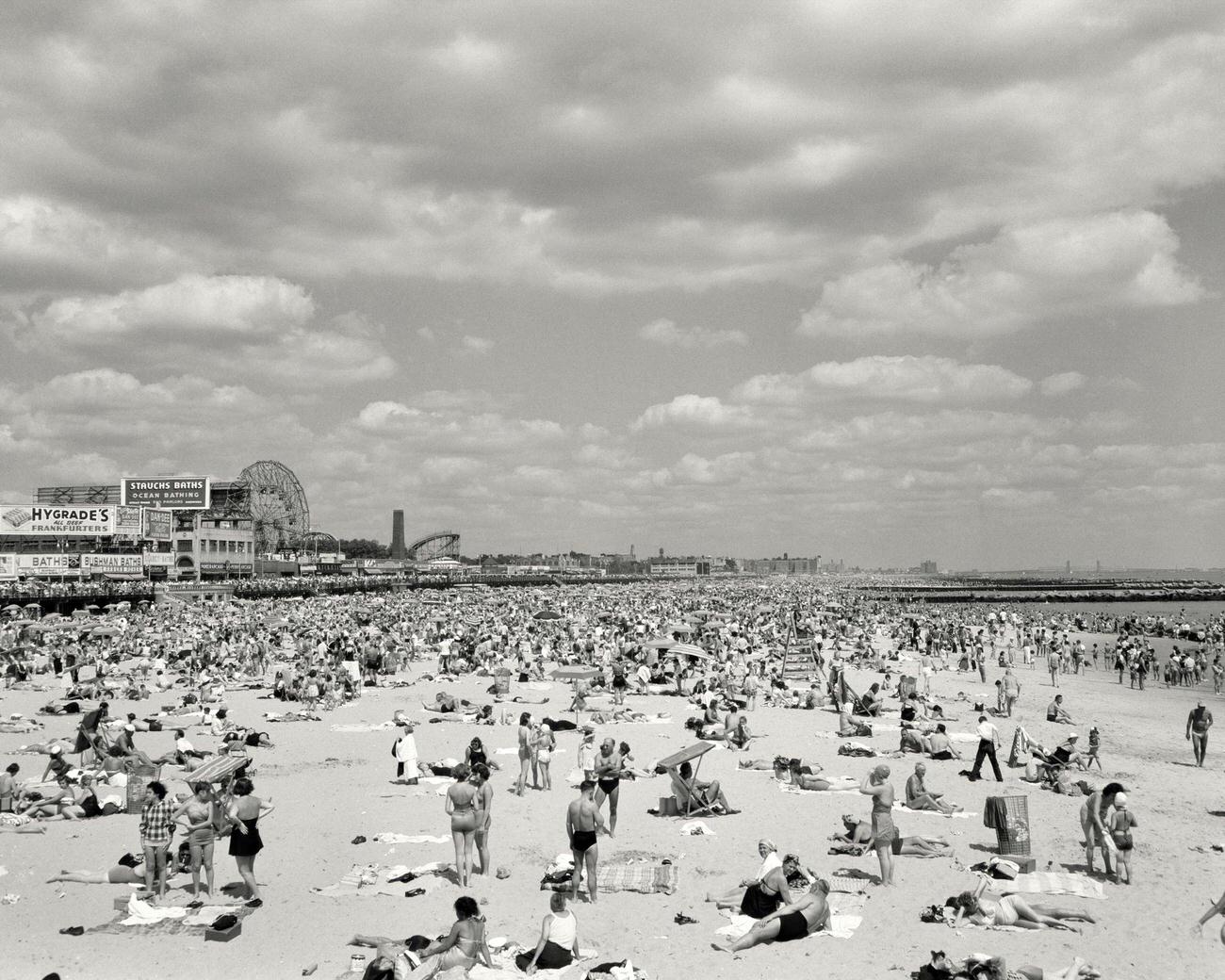 Crowded Beach With Amusement Park In Background