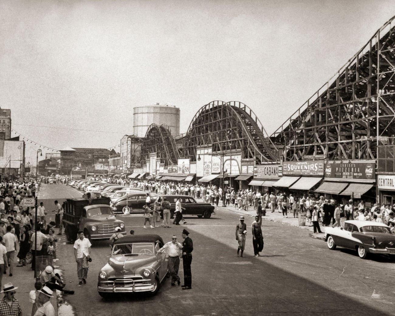 Crowded Streets And Parked Cars Near Roller Coaster, 1950S