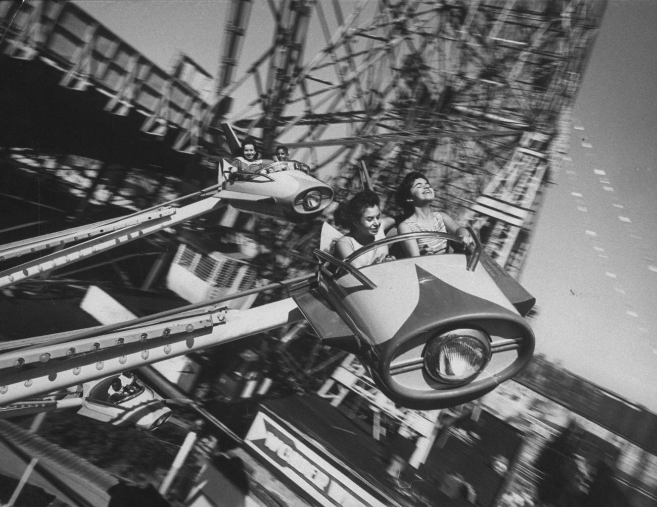Children Enjoy Airplane Ride In Amusement Park