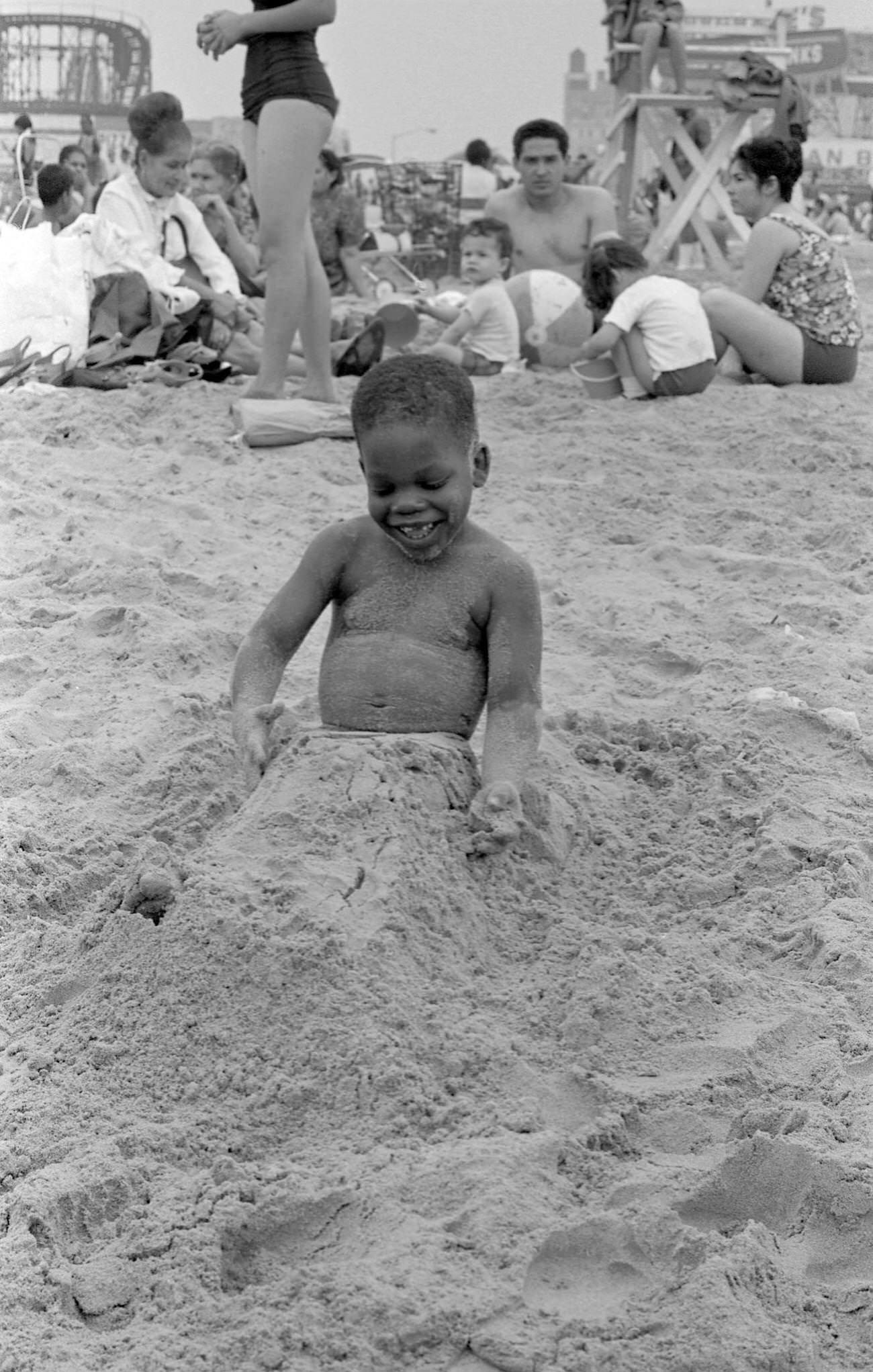 Laughing Boy Half-Buried In Coney Island Sand, 1968