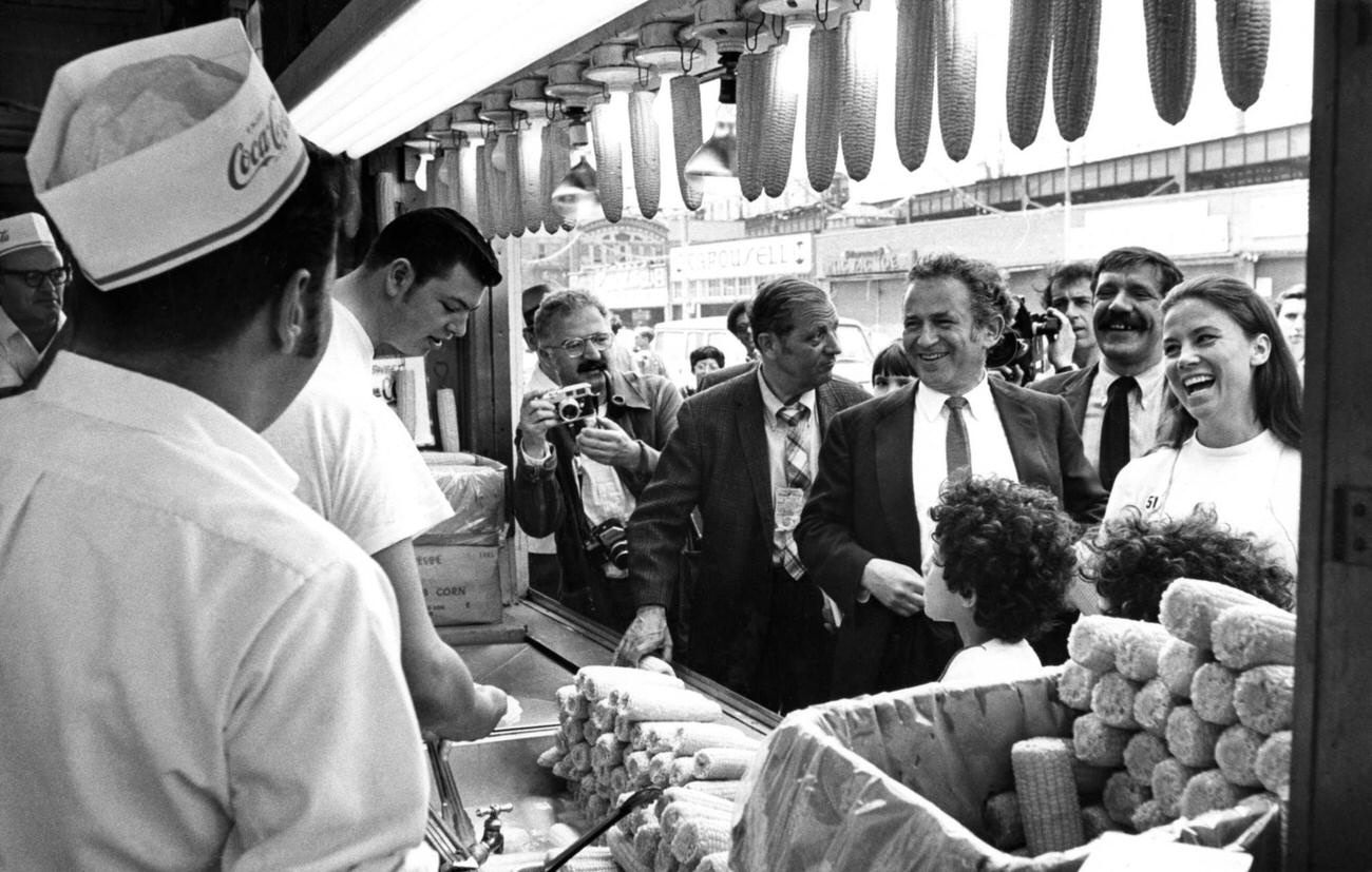 Norman Mailer Laughs With Corn Cob Vendors, Coney Island, 1969