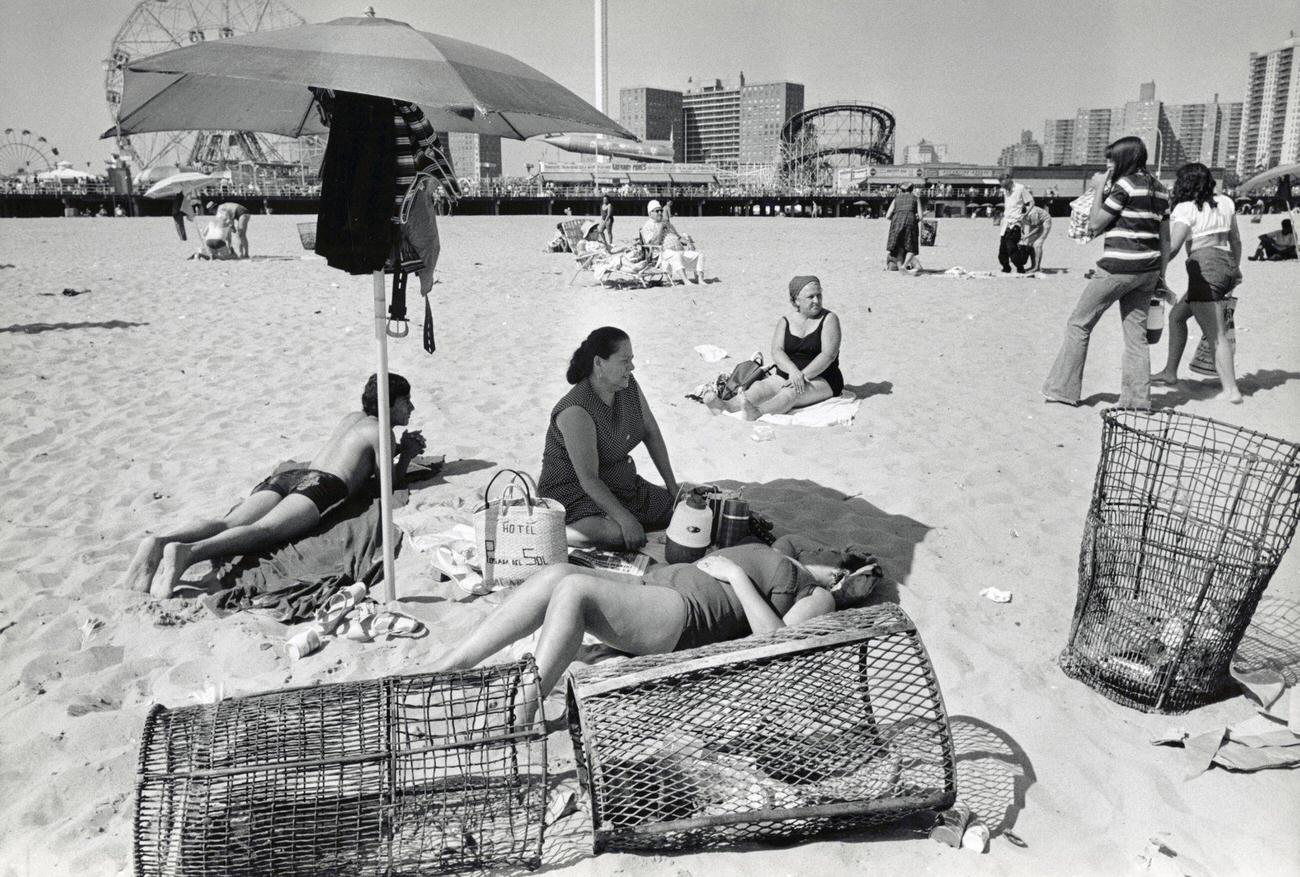Women Sunbathing Under A Parasol On Coney Island Beach, 1971