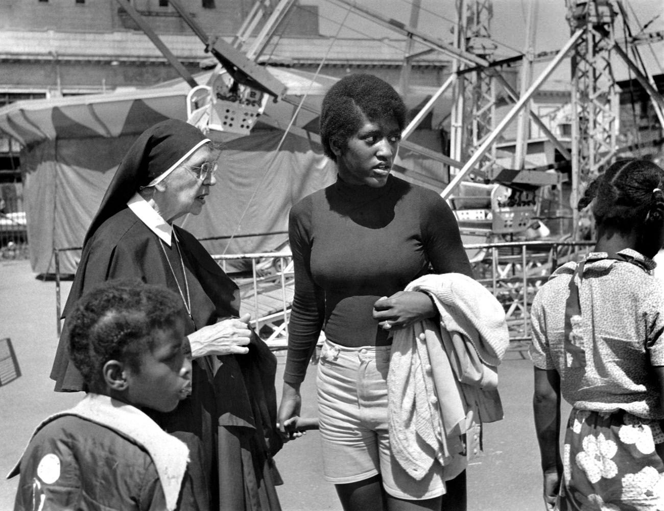 Nun Talking To Woman At Coney Island Amusement Park, 1973
