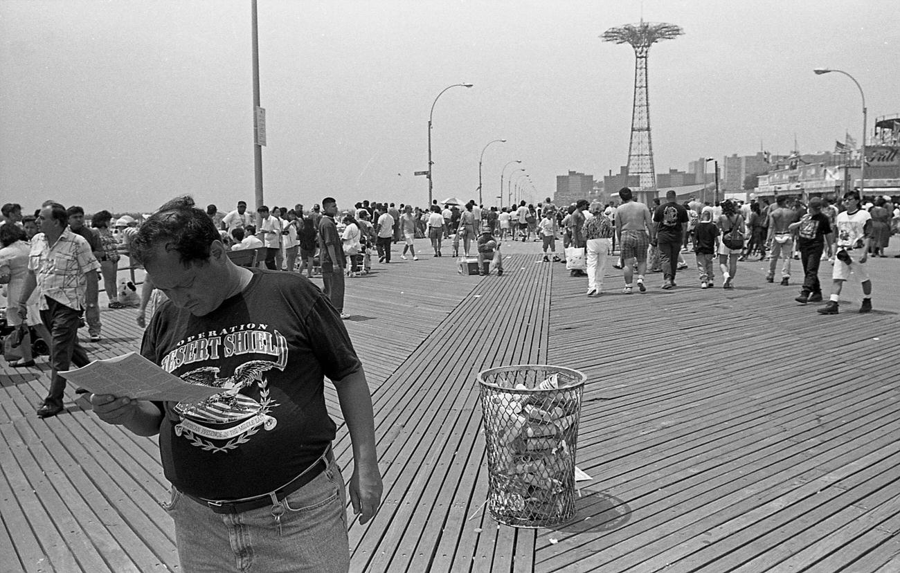 Man Reads Newspaper On Crowded Coney Island Boardwalk, 1995