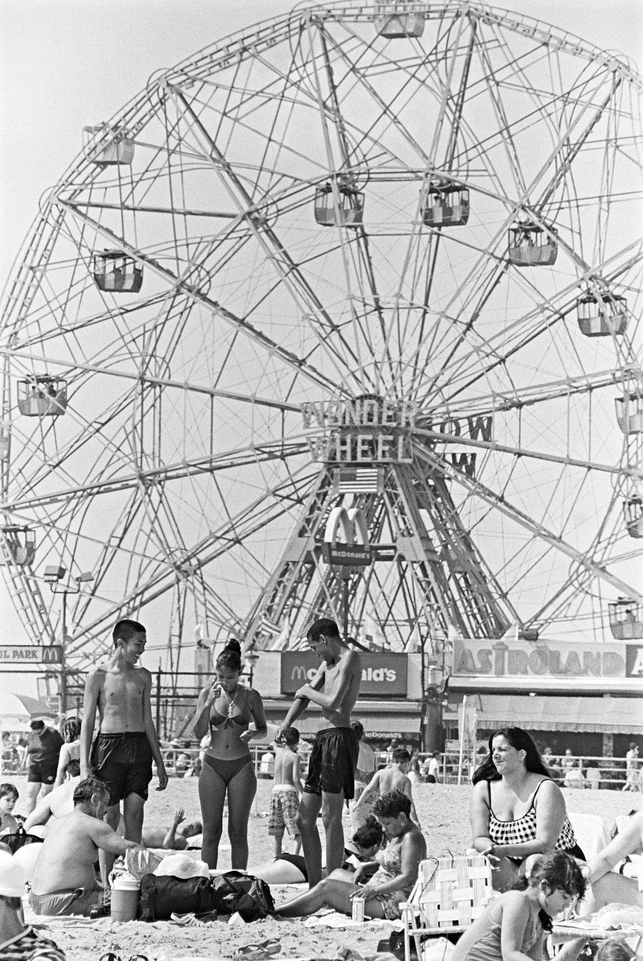 Beachgoers In Front Of Wonder Wheel, Coney Island, 1990S