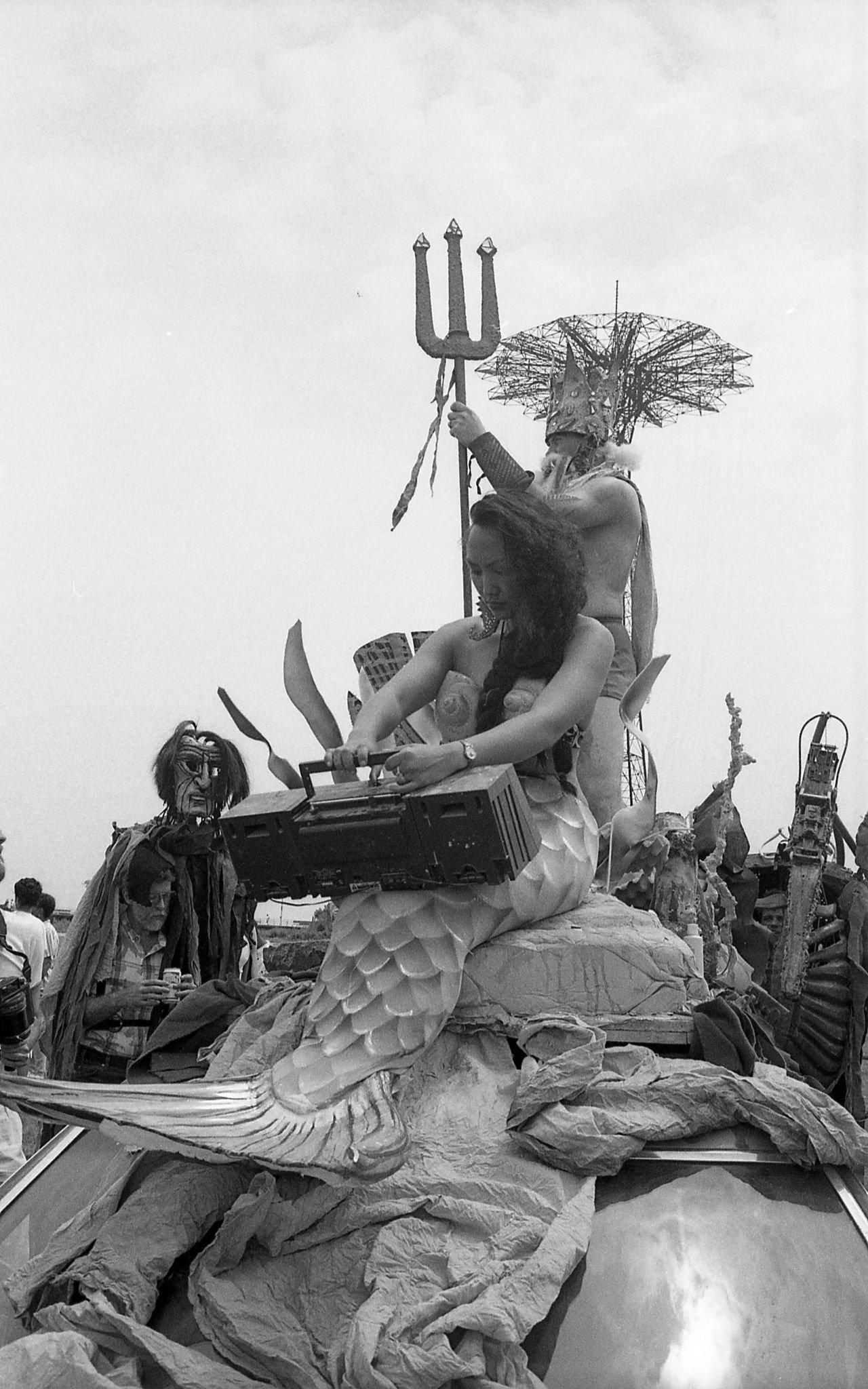 Woman In Mermaid Costume And Man As King Triton Ride On Vehicle At Coney Island Mermaid Parade, 1989