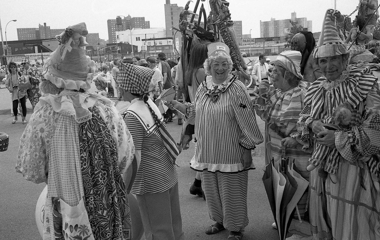 People In Clown Costumes Gather In Astroland Parking Lot For Coney Island Mermaid Parade, 1989