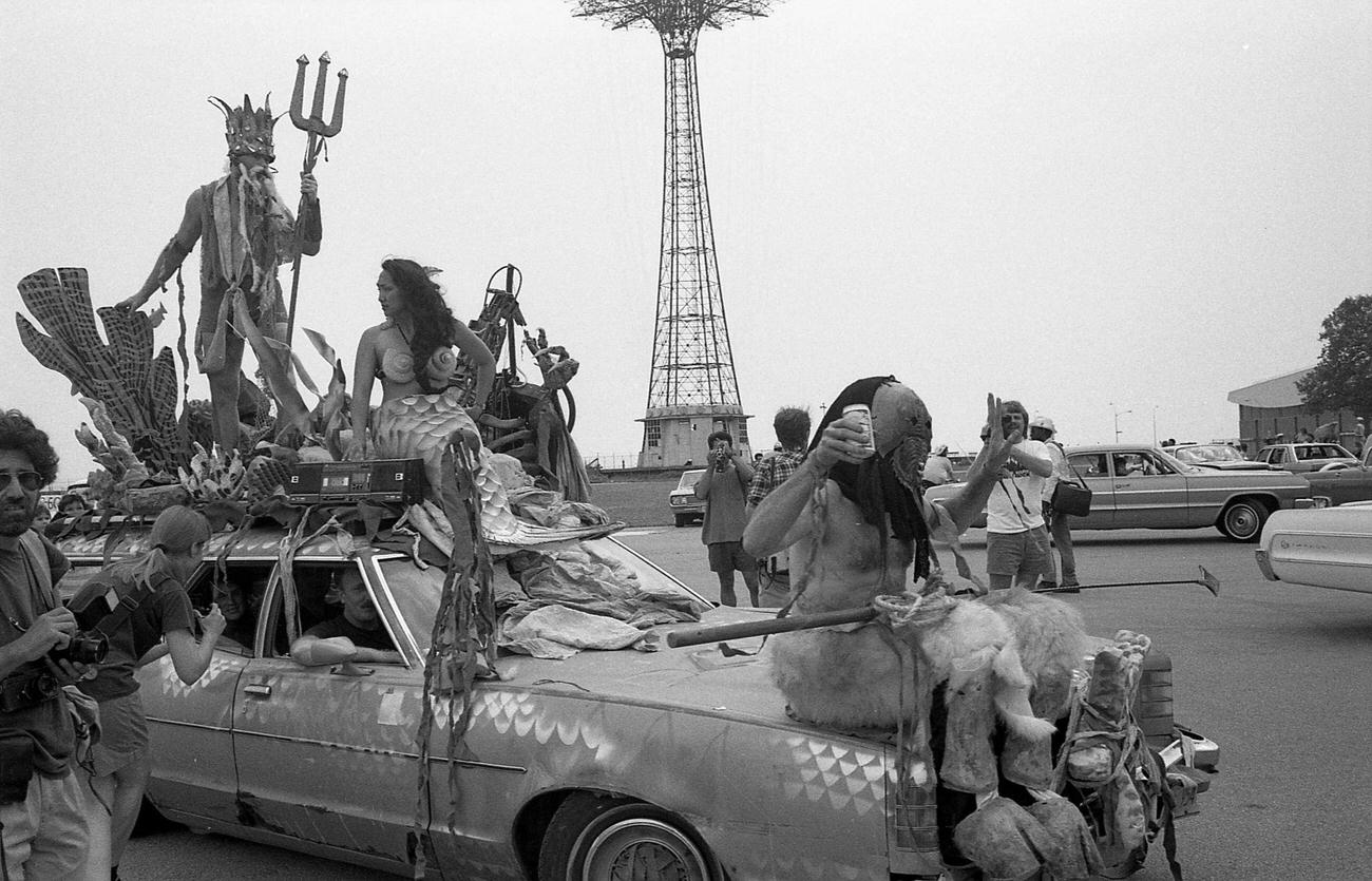 Trio Of Participants Pose On Station Wagon At Coney Island Mermaid Parade, 1989