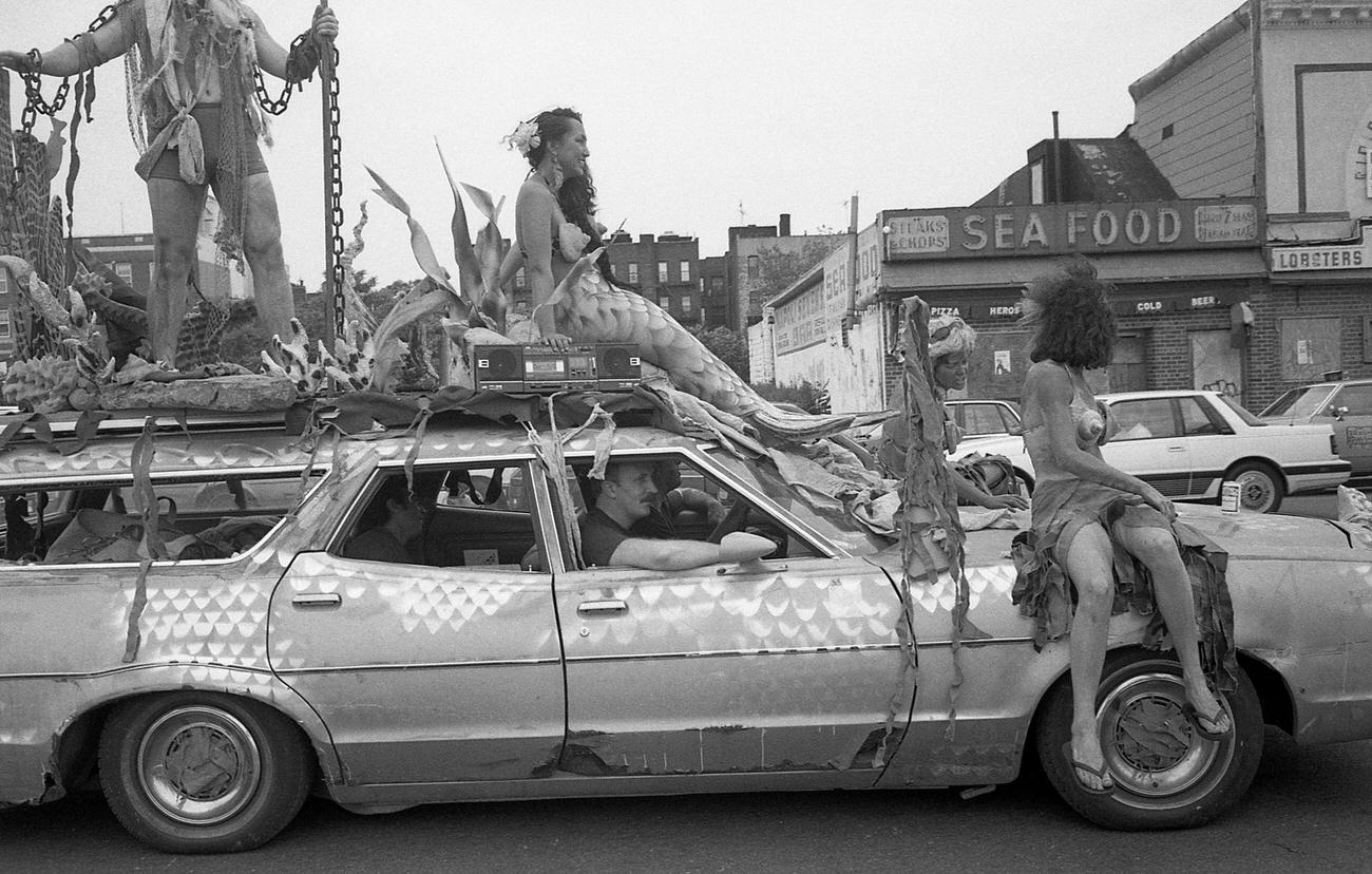 Women In Mermaid Costumes Ride On Decorated Station Wagon At Coney Island Mermaid Parade, 1989