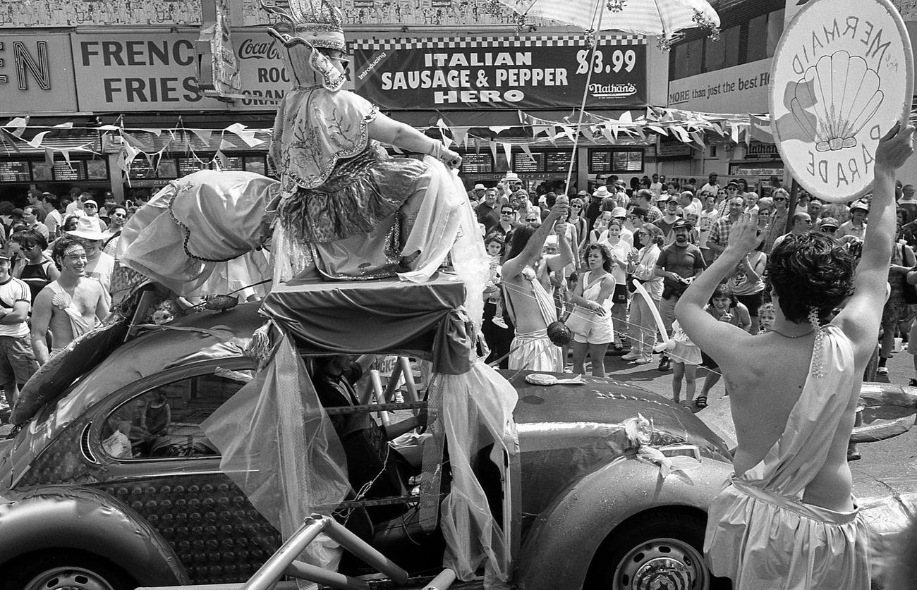 Man Dressed As King Rides Volkswagen Beetle At Coney Island Mermaid Parade, 1997