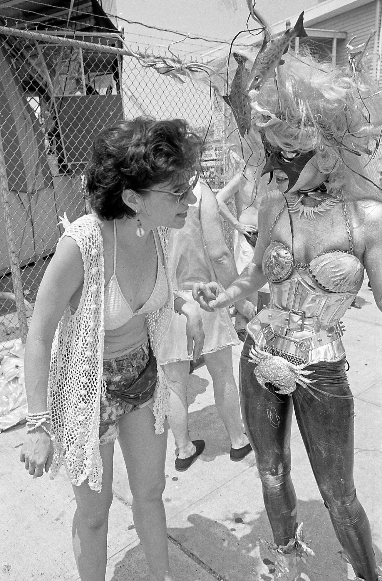 Woman Talks To Masked Mermaid At Coney Island Mermaid Parade, 1997