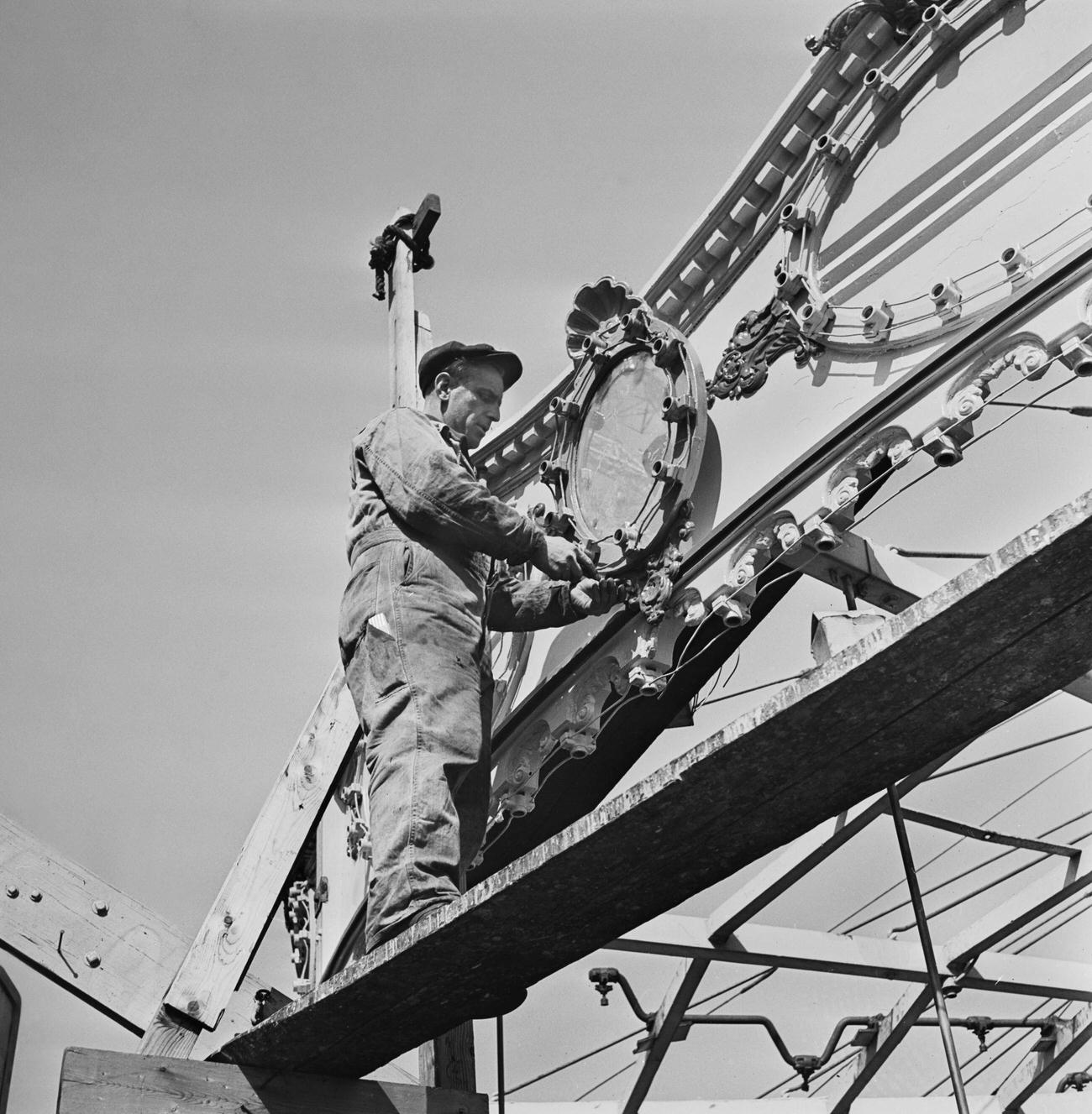 Labourer Repairing Funfair Lighting At Coney Island, 1950