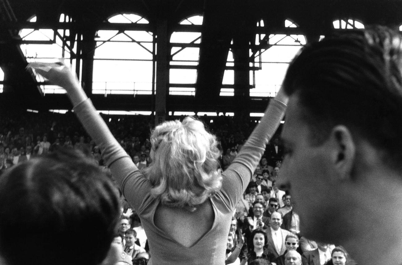 Marilyn Monroe Waves To Crowd During Soccer Kick-Off At Ebbets Field, 1957